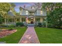 Inviting two-story home with a brick pathway, front porch, and well-maintained lawn at 53 Born St, Norcross, GA 30071
