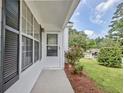 Welcoming entrance with black shutters, well-maintained landscaping, and a charming covered porch, perfect for relaxing at 470 Cornwallis Way, Fayetteville, GA 30214