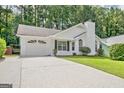 Inviting single-Gathering home with a paved driveway, attached garage and well-kept lawn surrounded by lush trees at 470 Cornwallis Way, Fayetteville, GA 30214