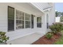 Close-up of the home's entrance, featuring a charming front door with sidelight windows and manicured landscaping at 470 Cornwallis Way, Fayetteville, GA 30214