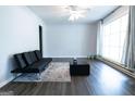 Spacious living room with large window, modern furniture, ceiling fan, and neutral decor at 1112 Mealor Rd, Lawrenceville, GA 30043