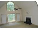 Bright living room featuring tall windows, fireplace, and vaulted ceiling at 3336 Harvester Woods Rd, Decatur, GA 30034