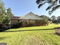 Spacious backyard showcasing a well-manicured lawn and mature trees providing shade and privacy at 601 Clubland Se Cir, Conyers, GA 30094