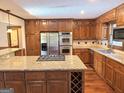 Gourmet kitchen featuring stainless steel appliances, custom cabinetry, and a large island with granite countertops at 601 Clubland Se Cir, Conyers, GA 30094