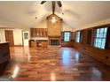 Bright living room with vaulted ceilings, hardwood floors, fireplace, and large windows filling the space with natural light at 601 Clubland Se Cir, Conyers, GA 30094