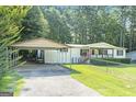 Charming single-story home with covered parking and a well-maintained lawn at 340 Loblolly Rdg, Locust Grove, GA 30248