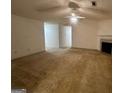 This Living Room features a fireplace and ceiling fan at 955 Foxworthy Ln, Riverdale, GA 30296
