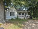 Charming one-story home with a covered front porch and mature trees at 443 Walker St, Villa Rica, GA 30180