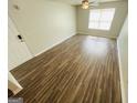 A bright living room with sleek flooring and a modern ceiling fan at 8201 Fairington Village Dr, Lithonia, GA 30038