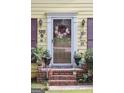 Charming home featuring a welcoming front door with a decorative wreath and colorful plants at 150 Ashley Dr, Fayetteville, GA 30214