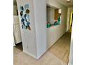 Hallway with neutral carpet paint leads to the kitchen, a nice transition between the spaces at 3219 Fairington Dr, Lithonia, GA 30038