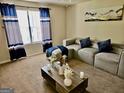 Inviting living room features neutral tones, plush seating, and bright natural light from a large window at 3219 Fairington Dr, Lithonia, GA 30038