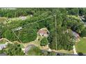 Aerial view of a wooded 2.06 acre lot featuring a brick home with a circular driveway at 285 Acton Dr, Fayetteville, GA 30215