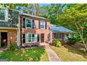 Beautiful brick townhome with lush front lawn and mature trees at 398 Patrick Henry Ct, Riverdale, GA 30274