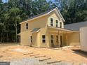 View of the home's rear showcasing a covered porch and newly installed siding at 5555 Hwy 155 N, Stockbridge, GA 30281