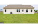 Expansive, newly seeded backyard featuring a pristine lawn with a freshly installed air conditioning unit at 1512 Big Bud Ln, Locust Grove, GA 30248