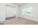 Bright living room with plush carpeting, fresh neutral paint, and a large window providing ample natural light at 1512 Big Bud Ln, Locust Grove, GA 30248