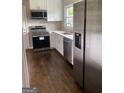 Bright, modern kitchen with stainless steel appliances and white cabinets at 90 Pat Mell Sw Rd, Marietta, GA 30060