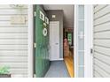 Inviting entrance view with a green front door, sidelight, and foyer with hardwood floors at 512 Las Brasis Ct, Peachtree City, GA 30269