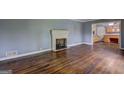 Spacious living room features a fireplace and gleaming hardwood floors at 2742 Highway 20 W, Hampton, GA 30228
