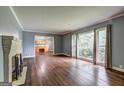 Bright living room featuring hardwood floors, fireplace and large windows at 2742 Highway 20 W, Hampton, GA 30228
