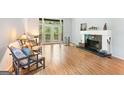 Bright living room with a fireplace, wood floors, and french doors to a deck at 1677 Terrell Ridge Se Dr, Marietta, GA 30067