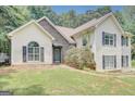 Charming two-story home with vinyl siding and a stone facade and manicured lawn at 70 N Strathmore Dr, Sharpsburg, GA 30277
