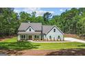 Inviting light blue two-story home with a covered front porch and pristine landscaping at 4585 Parkwood Rd, Social Circle, GA 30025