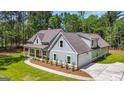 A well-maintained, light blue two-story home with an attached garage and a lush green lawn at 4585 Parkwood Rd, Social Circle, GA 30025