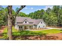 Attractive two-story home featuring a covered front porch and a well-manicured front lawn at 4585 Parkwood Rd, Social Circle, GA 30025