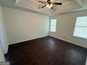 Inviting bedroom with tray ceilings, neutral walls, and large windows providing ample light at 6372 Stonebridge Creek Ln, Lithonia, GA 30058