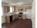 Functional kitchen featuring stainless steel appliances, wood cabinets, and durable countertops at 6372 Stonebridge Creek Ln, Lithonia, GA 30058