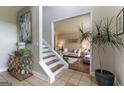 Warm and inviting foyer features a staircase, decorative table, and seamless transition to the adjacent living room at 130 Bexar Ct, Johns Creek, GA 30022