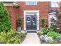 Elegant front entrance showcasing a double door, lovely landscaping, and decorative plants leading up to the doorway at 130 Bexar Ct, Johns Creek, GA 30022