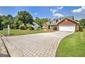 Paver driveway leading to a well-maintained single-Gathering home with lush green landscaping at 316 Kensington Dr, Peachtree City, GA 30269
