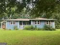 Charming single-story home featuring a welcoming front porch and well-kept landscaping at 1041 Sandy Ridge Rd, Mcdonough, GA 30252