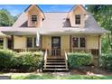 Inviting front porch with wooden steps and decorative bushes leading to the entrance at 292 Selfridge Rd, Mcdonough, GA 30252