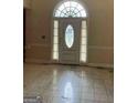 Bright entryway featuring a decorative front door and tile floors at 145 Windy Ridge Ct, Fayetteville, GA 30214