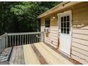 Exterior deck featuring weathered wood, railing, and access door at 4014 Oak Stone Dr, Douglasville, GA 30135