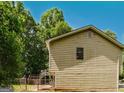 Side view of house and the lush greenery surrounding it showcases its serene location at 4014 Oak Stone Dr, Douglasville, GA 30135