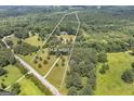 Expansive aerial view of the property showcasing 15.91 acres of lush greenery and the home's serene setting at 949 Amelia Rd, Locust Grove, GA 30248