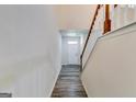 Bright entryway featuring hardwood flooring, a staircase, and fresh, neutral paint at 121 Wellbrook Circle Ne, Conyers, GA 30012