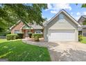 View of the home, garage, and driveway, showcasing well-kept landscaping and a brick and siding exterior at 20 Knollwood Pl, Covington, GA 30014