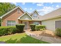 Charming brick home with well-manicured landscaping and a welcoming front entrance with a decorative wreath at 20 Knollwood Pl, Covington, GA 30014