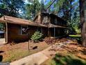 Charming two-story home with wood siding, brick chimney, and covered front porch at 963 Blackberry Ct, Ellenwood, GA 30294