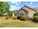 Home exterior with stone and siding details, surrounded by manicured landscaping and lush greenery at 275 Rehobeth Way, Fayetteville, GA 30214