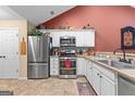 Well-equipped kitchen featuring stainless steel appliances, granite countertops, and white cabinetry at 275 Rehobeth Way, Fayetteville, GA 30214