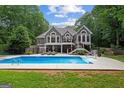 Backyard view with large in-ground pool, spacious patio, and fenced yard at 9125 Patrick Pl, Winston, GA 30187