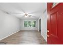 Bright living room showcasing new flooring, fresh paint, a ceiling fan, and a view of the front yard at 260 Pinehurst Dr, Stockbridge, GA 30281