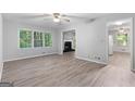Open-concept living room with new flooring, a fireplace, and views into other rooms at 260 Pinehurst Dr, Stockbridge, GA 30281
